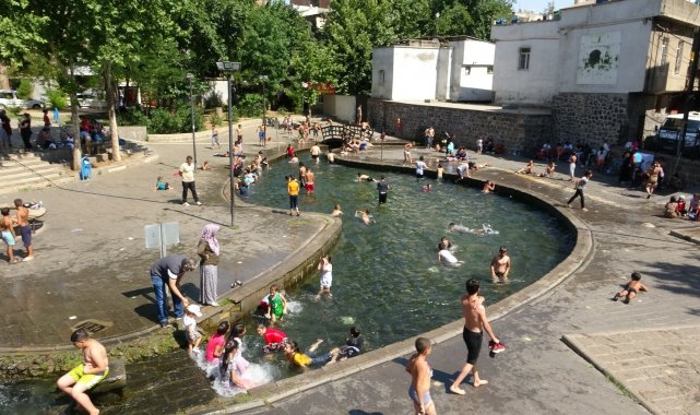 Diyarbakır'da sıcaktan bunalan çocuklar süs havuzlarını doldurdu